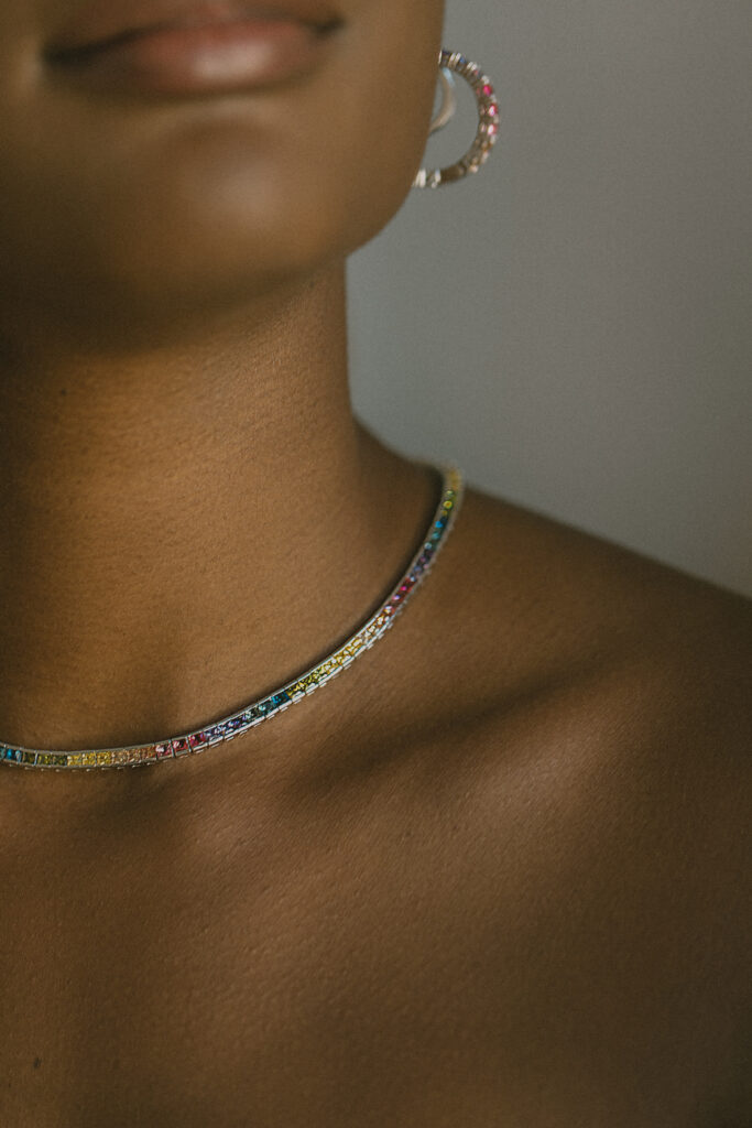 Prism (woman wearing multi-color silver necklace)
