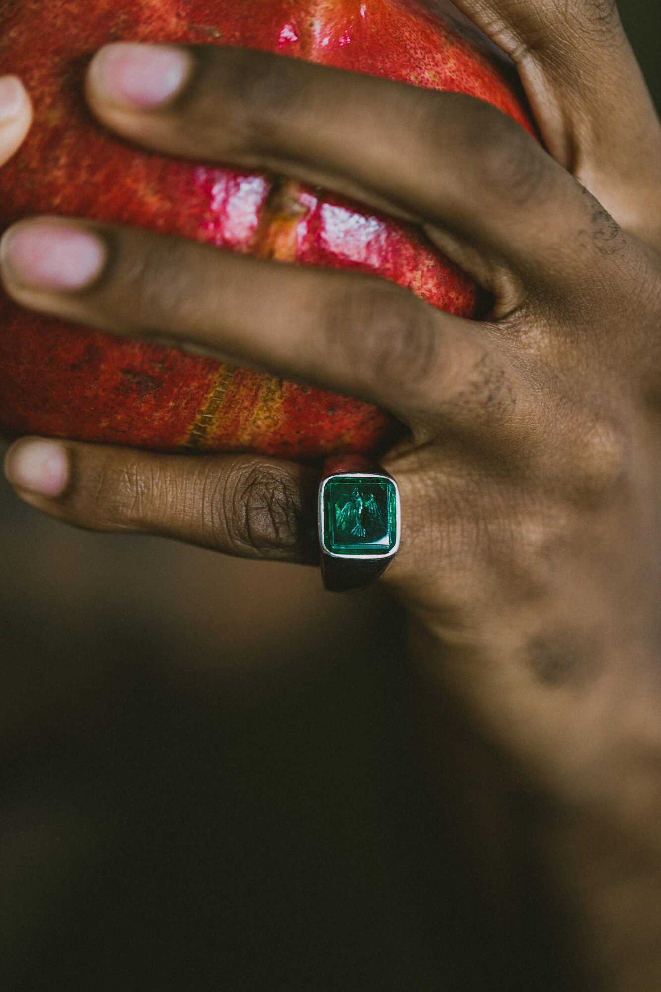 man wearing emerald ring